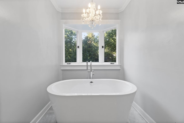415 Pine St, Camden, SC 29020 - full bath with baseboards, a soaking tub, ornamental molding, and a chandelier