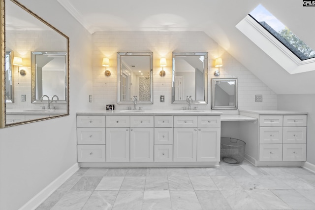 415 Pine St, Camden, SC 29020 - full bathroom featuring a skylight, double vanity, vaulted ceiling, baseboards, and marble finish flooring