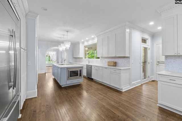 415 Pine St, Camden, SC 29020 - kitchen with appliances with stainless steel finishes, light countertops, crown molding, white cabinetry, and dark wood-style flooring