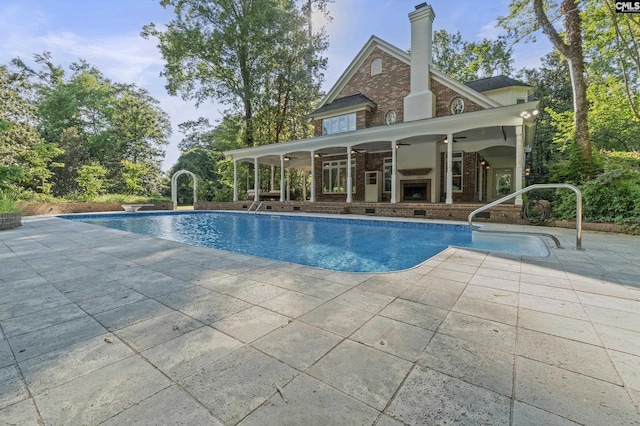 415 Pine St, Camden, SC 29020 - swimming pool with a ceiling fan, a patio area, and exterior fireplace