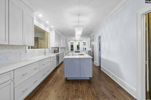 415 Pine St, Camden, SC 29020 - kitchen featuring a kitchen island, appliances with stainless steel finishes, a sink, white cabinetry, and ornamental molding