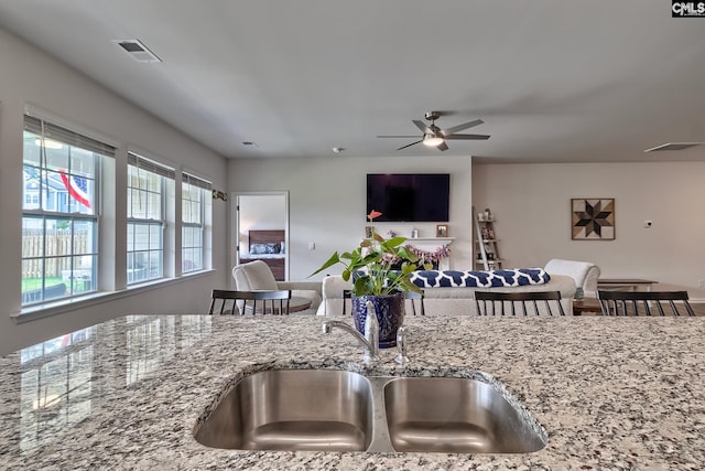 837 Marigold Ln, Lexington, SC 29072 - kitchen featuring a sink, ceiling fan, light stone counters, and open floor plan