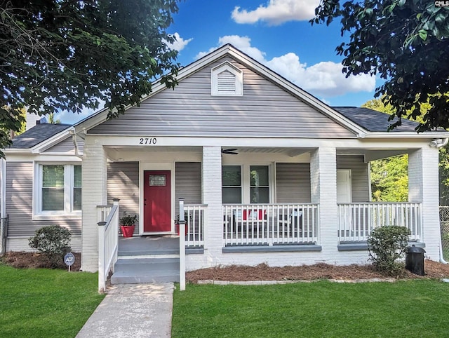 2710 Columbia Ave, Columbia, SC 29201 - view of front of home featuring a porch, a front yard, brick siding, and roof with shingles
