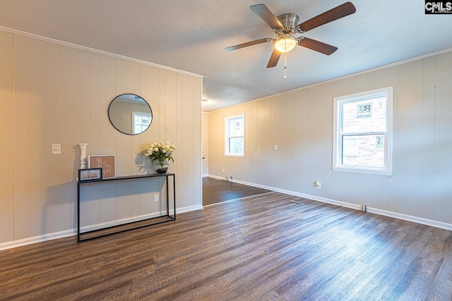 711 Parrish Dr, Mullins, SC 29574 - empty room featuring wood finished floors, a ceiling fan, a textured ceiling, crown molding, and baseboards