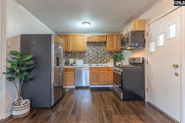 711 Parrish Dr, Mullins, SC 29574 - kitchen with appliances with stainless steel finishes, light countertops, dark wood-type flooring, a sink, and decorative backsplash