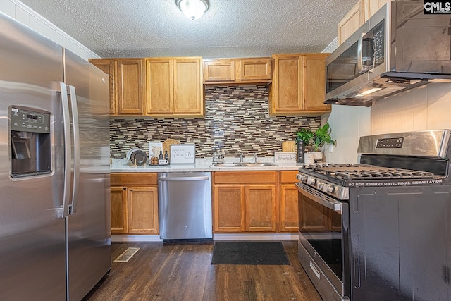 711 Parrish Dr, Mullins, SC 29574 - kitchen featuring appliances with stainless steel finishes, light countertops, dark wood-style flooring, a textured ceiling, and a sink