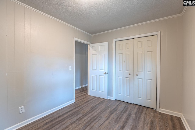 711 Parrish Dr, Mullins, SC 29574 - unfurnished bedroom featuring dark wood finished floors, a textured ceiling, a closet, baseboards, and crown molding