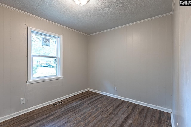 711 Parrish Dr, Mullins, SC 29574 - spare room featuring dark wood finished floors, ornamental molding, a textured ceiling, and baseboards