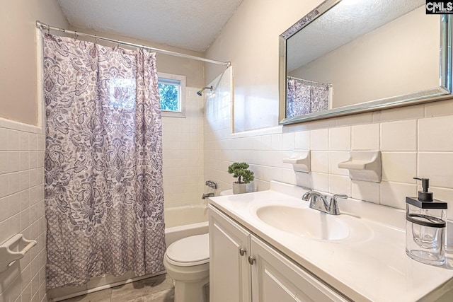 711 Parrish Dr, Mullins, SC 29574 - full bath featuring tile walls, a textured ceiling, vanity, shower / bath combo with shower curtain, and toilet