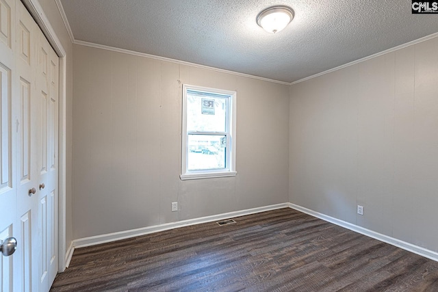 711 Parrish Dr, Mullins, SC 29574 - unfurnished bedroom with dark wood finished floors, a closet, a textured ceiling, crown molding, and baseboards