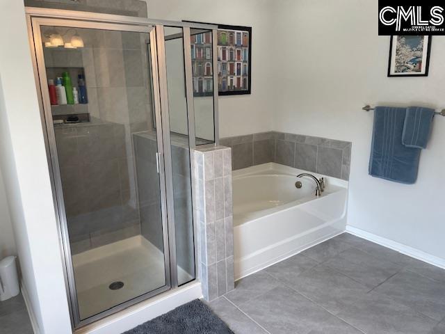 288 Links Crossing Dr, Blythewood, SC 29016 - full bathroom featuring a shower stall, a garden tub, tile patterned floors, and baseboards