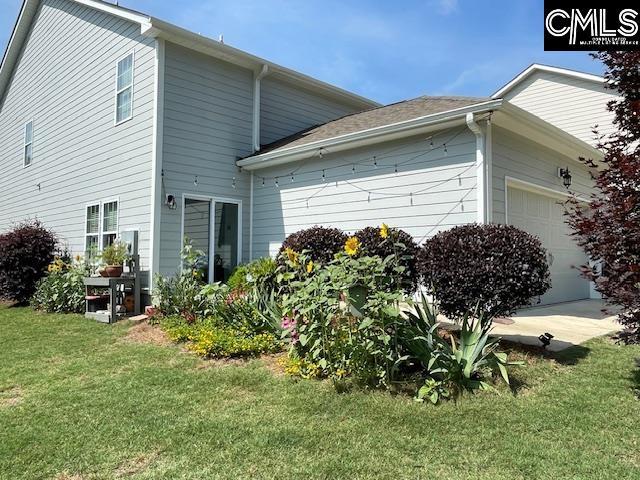 288 Links Crossing Dr, Blythewood, SC 29016 - view of home's exterior with an attached garage and a lawn