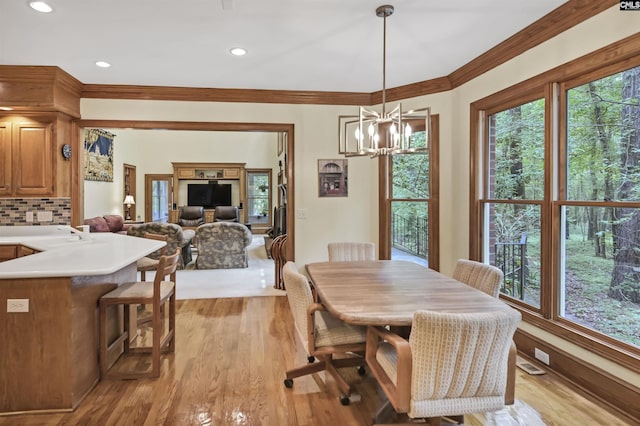 832 Longtown Rd, Blythewood, SC 29016 - dining room featuring a chandelier, crown molding, light wood finished floors, and recessed lighting