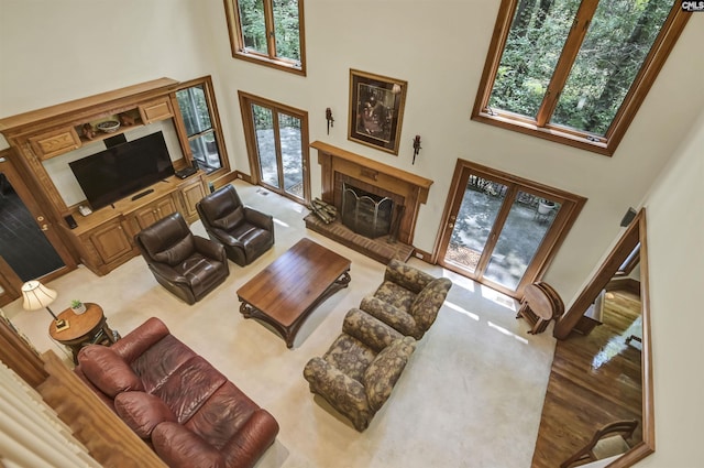 832 Longtown Rd, Blythewood, SC 29016 - living room featuring a towering ceiling, a fireplace with raised hearth, carpet floors, french doors, and baseboards