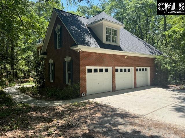 832 Longtown Rd, Blythewood, SC 29016 - view of side of home featuring concrete driveway, brick siding, and an attached garage