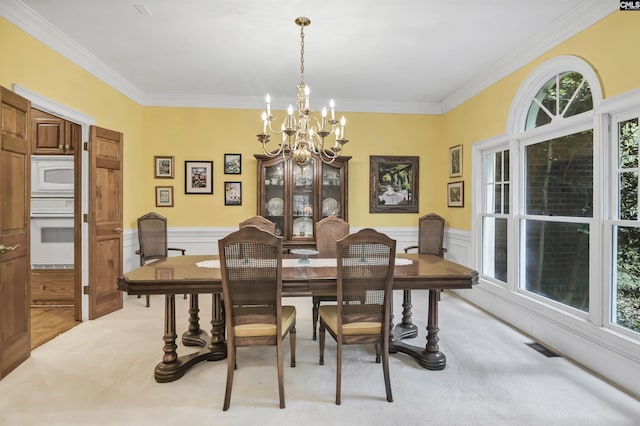 832 Longtown Rd, Blythewood, SC 29016 - dining room with a chandelier, ornamental molding, light carpet, plenty of natural light, and wainscoting