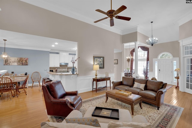 317 Cartgate Cir, Blythewood, SC 29016 - living area featuring crown molding, a chandelier, a ceiling fan, a high ceiling, and light wood-style flooring