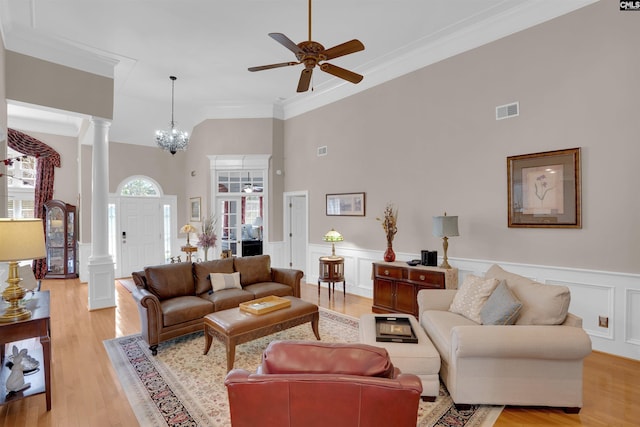 317 Cartgate Cir, Blythewood, SC 29016 - living area with decorative columns, a ceiling fan, a decorative wall, crown molding, and light wood finished floors