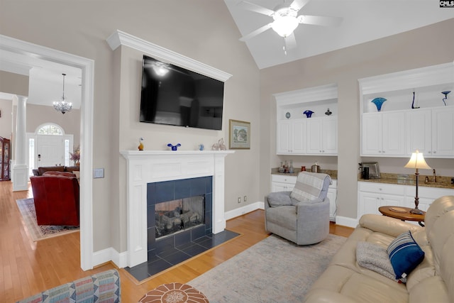 317 Cartgate Cir, Blythewood, SC 29016 - living area with ceiling fan, light wood-type flooring, a fireplace, high vaulted ceiling, and baseboards