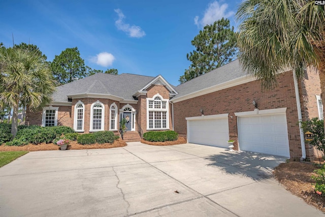 317 Cartgate Cir, Blythewood, SC 29016 - view of front of home featuring concrete driveway, brick siding, roof with shingles, and an attached garage