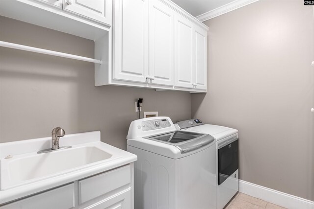 317 Cartgate Cir, Blythewood, SC 29016 - laundry room with washer and clothes dryer, cabinet space, crown molding, light tile patterned flooring, and baseboards