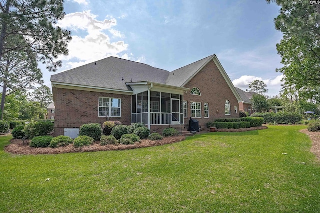 317 Cartgate Cir, Blythewood, SC 29016 - rear view of house with brick siding, a sunroom, a lawn, and a shingled roof