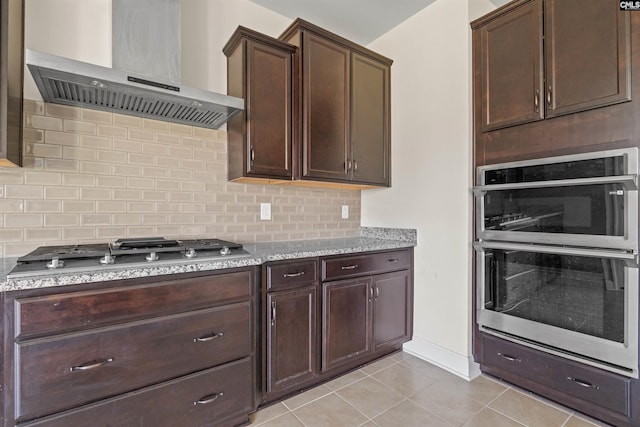 1412 Hammerwood Ln, Westminster, SC 29170 - kitchen featuring exhaust hood, stainless steel appliances, backsplash, dark brown cabinetry, and light tile patterned flooring