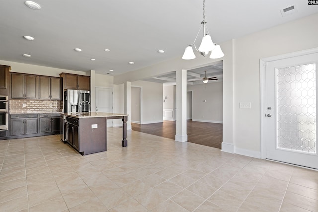 1412 Hammerwood Ln, Westminster, SC 29170 - kitchen featuring recessed lighting, backsplash, a breakfast bar area, dark brown cabinets, and a center island with sink