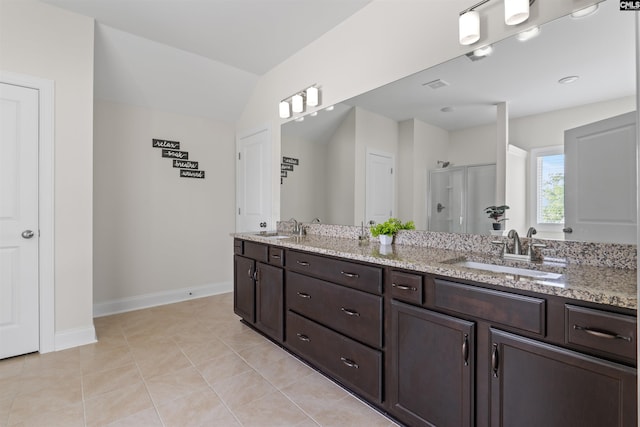 1412 Hammerwood Ln, Westminster, SC 29170 - bathroom featuring double vanity, baseboards, a shower stall, vaulted ceiling, and tile patterned floors