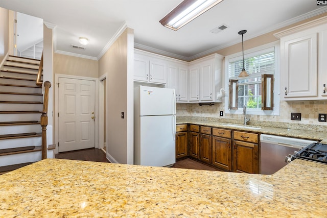 560 Park Place Dr, Elgin, SC 29045 - kitchen with freestanding refrigerator, a sink, dishwashing machine, ornamental molding, and decorative backsplash