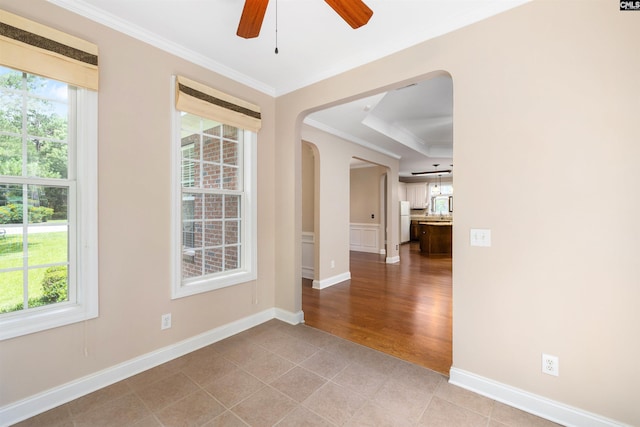 560 Park Place Dr, Elgin, SC 29045 - spare room featuring arched walkways, crown molding, ceiling fan, baseboards, and light tile patterned floors