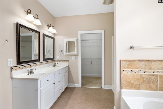 560 Park Place Dr, Elgin, SC 29045 - full bathroom featuring a bath, double vanity, tile patterned flooring, a spacious closet, and baseboards
