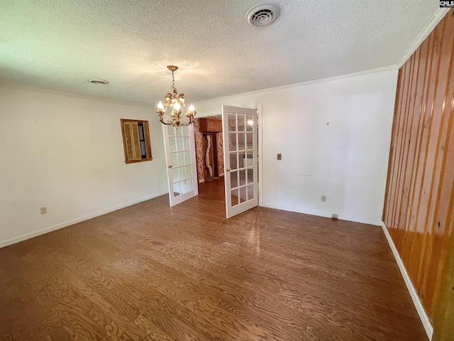 325 Beltline Ave, Batesburg, SC 29006 - spare room featuring french doors, dark wood-type flooring, a chandelier, a textured ceiling, and crown molding