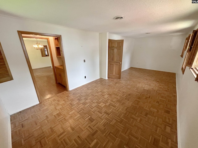325 Beltline Ave, Batesburg, SC 29006 - spare room featuring a chandelier, a textured ceiling, and baseboards