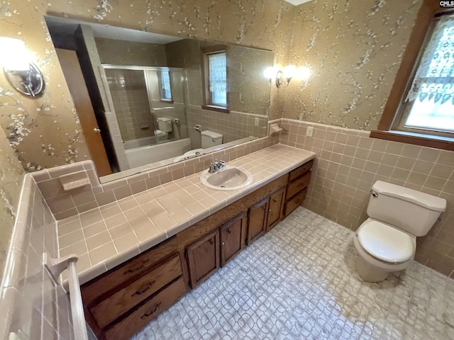 325 Beltline Ave, Batesburg, SC 29006 - full bathroom with tile walls, toilet, vanity, plenty of natural light, and wainscoting
