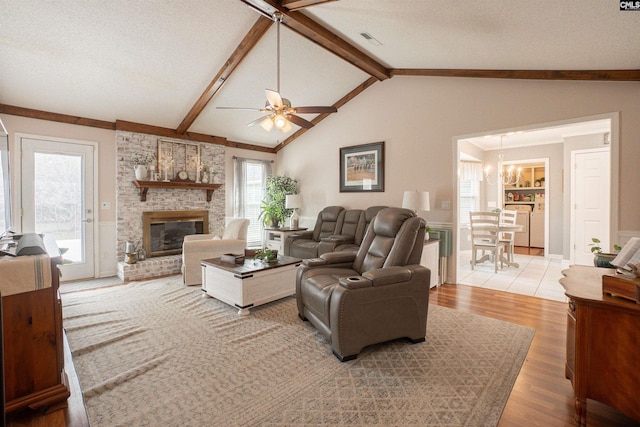 285 Freedom Blvd, Sumter, SC 29154 - living area featuring a brick fireplace, ceiling fan, light wood-style flooring, a chandelier, and a textured ceiling