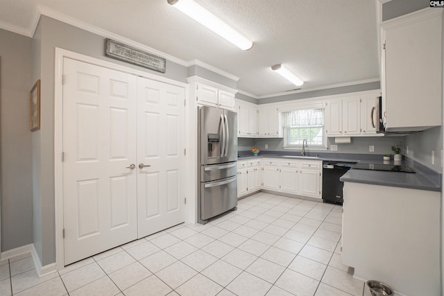 285 Freedom Blvd, Sumter, SC 29154 - kitchen featuring appliances with stainless steel finishes, ornamental molding, light tile patterned flooring, white cabinets, and a textured ceiling