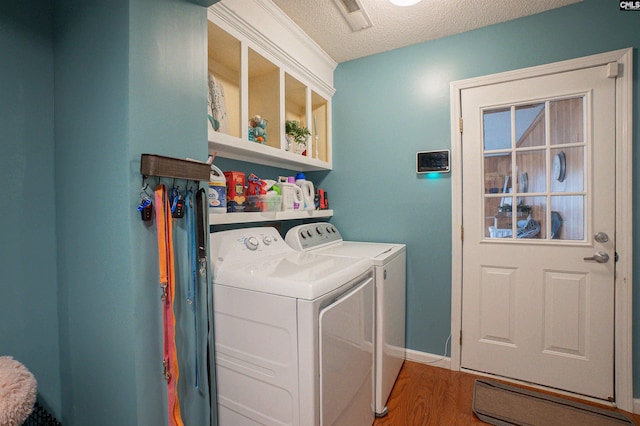 285 Freedom Blvd, Sumter, SC 29154 - laundry area with washing machine and clothes dryer, wood finished floors, and a textured ceiling