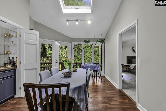 1305 Forest View Rd, Conway, SC 29526 - dining space with dark wood-style floors, a skylight, vaulted ceiling, french doors, and baseboards