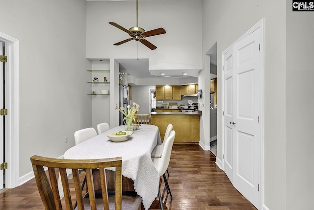 1305 Forest View Rd, Conway, SC 29526 - dining room featuring a ceiling fan, dark wood-style floors, baseboards, and a towering ceiling