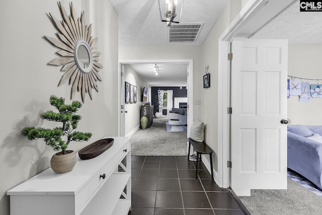1305 Forest View Rd, Conway, SC 29526 - hall with dark colored carpet, a textured ceiling, dark tile patterned floors, and baseboards