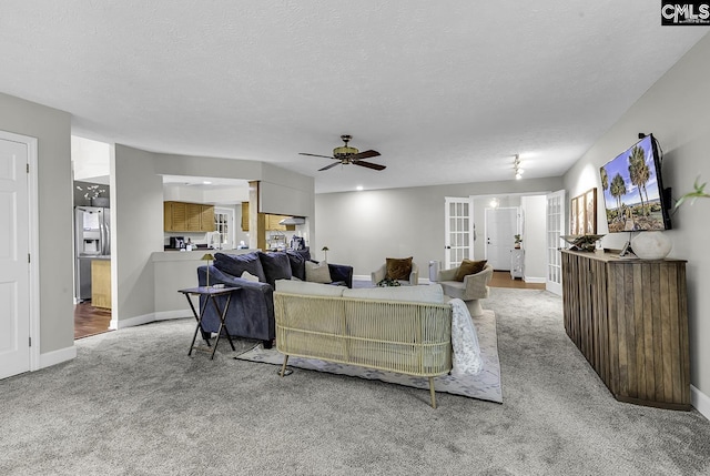 1305 Forest View Rd, Conway, SC 29526 - carpeted living area with french doors, ceiling fan, baseboards, and a textured ceiling