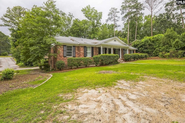 6307 Whiteoak Rd, Columbia, SC 29206 - view of front of house featuring brick siding, a front lawn, and a chimney