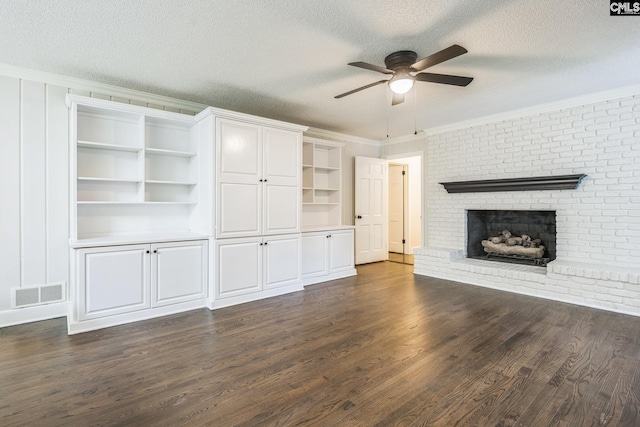 6307 Whiteoak Rd, Columbia, SC 29206 - unfurnished living room featuring a ceiling fan, dark wood-style flooring, crown molding, a brick fireplace, and a textured ceiling