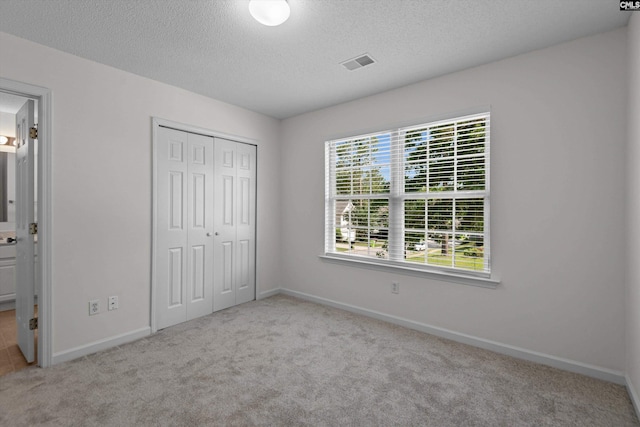 125 Oak Cove Dr, Columbia, SC 29229 - unfurnished bedroom with carpet flooring, a closet, a textured ceiling, baseboards, and ensuite bathroom