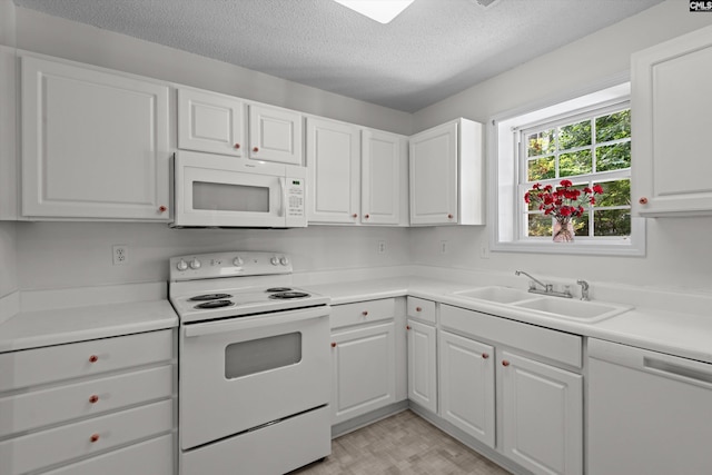 125 Oak Cove Dr, Columbia, SC 29229 - kitchen with white appliances, a sink, a textured ceiling, white cabinetry, and light countertops