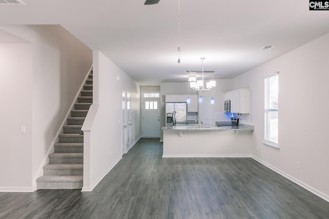 179 Marissa Ln, Lexington, SC 29072 - kitchen featuring stainless steel appliances, a peninsula, white cabinets, and dark wood-style floors