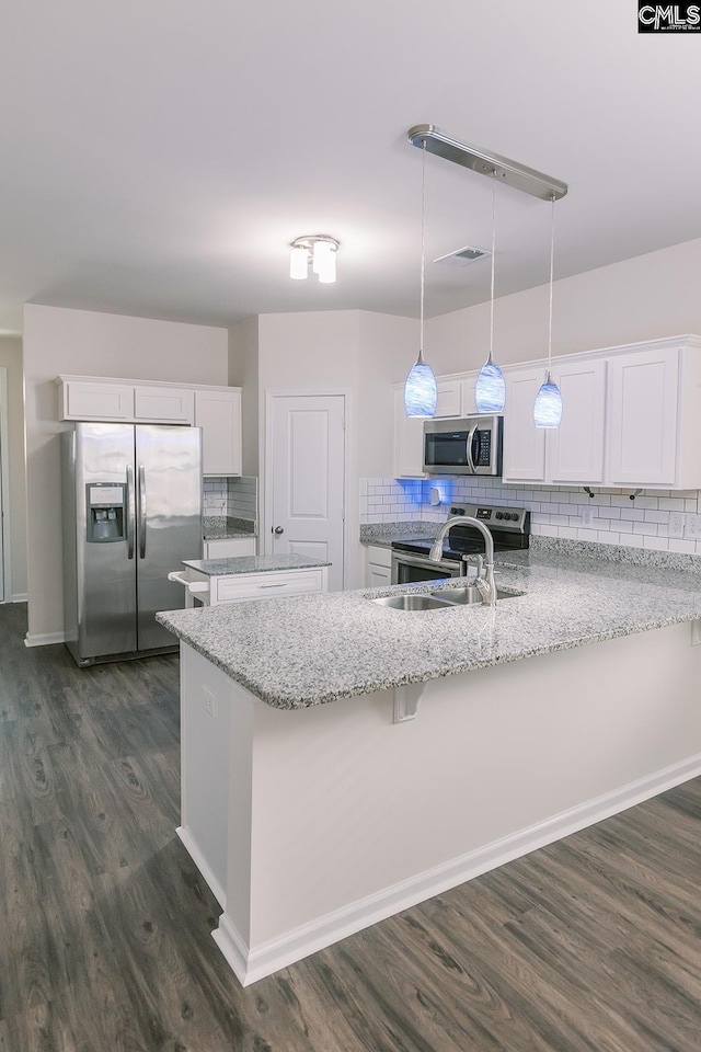 179 Marissa Ln, Lexington, SC 29072 - kitchen featuring stainless steel appliances, a peninsula, dark wood-style flooring, backsplash, and white cabinetry