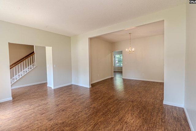 105 Songbird Ct, Chapin, SC 29036 - unfurnished room featuring a chandelier, dark wood-type flooring, stairway, and baseboards