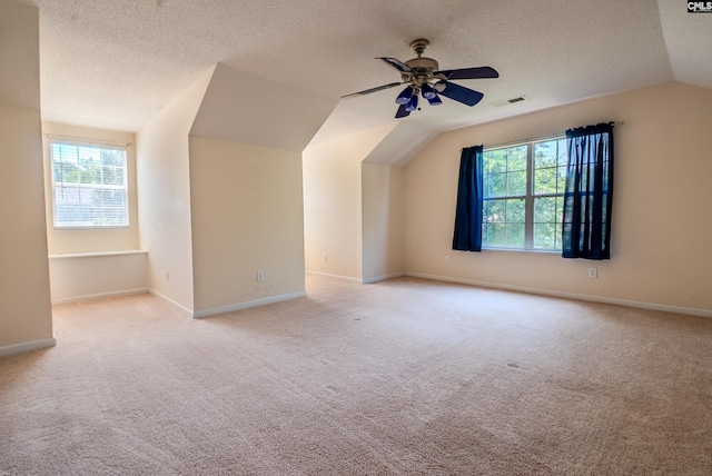 105 Songbird Ct, Chapin, SC 29036 - bonus room featuring vaulted ceiling, light carpet, plenty of natural light, a ceiling fan, and a textured ceiling